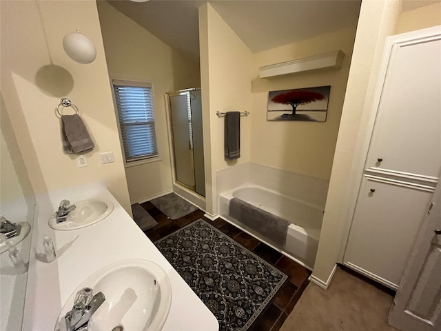 bathroom featuring vanity, shower with separate bathtub, and lofted ceiling