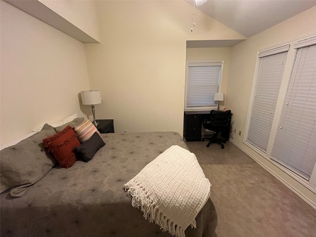 carpeted bedroom featuring vaulted ceiling