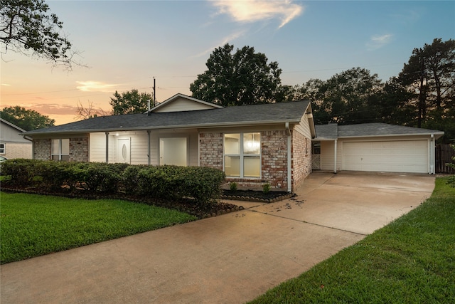 view of front facade with a garage and a yard