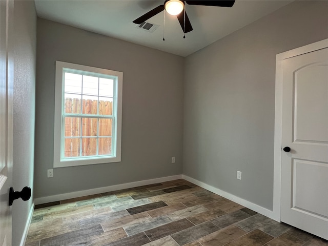 empty room featuring ceiling fan and dark hardwood / wood-style floors