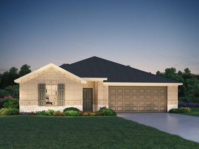 view of front facade featuring a lawn and a garage