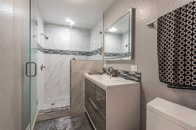 bathroom with toilet, a textured ceiling, decorative backsplash, sink, and a shower with door