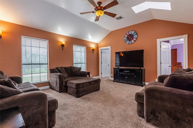 living room featuring ceiling fan, light colored carpet, and lofted ceiling