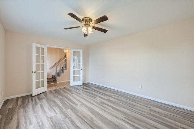 spare room featuring french doors, light hardwood / wood-style floors, and ceiling fan