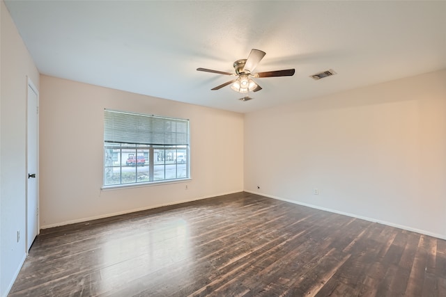 spare room featuring dark hardwood / wood-style floors and ceiling fan