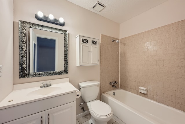 full bathroom featuring vanity, a textured ceiling, tiled shower / bath combo, tile patterned flooring, and toilet