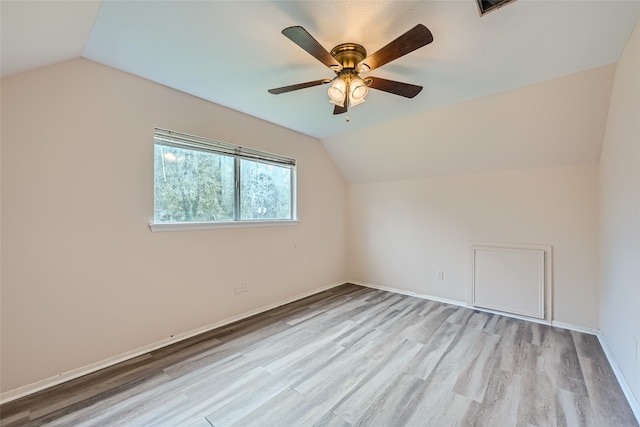 additional living space with ceiling fan, light hardwood / wood-style flooring, and lofted ceiling