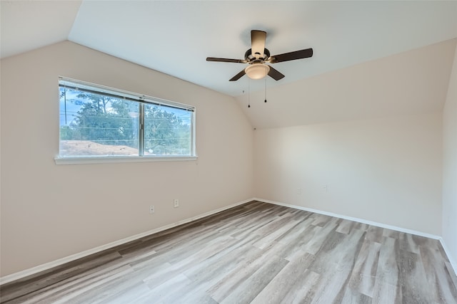 unfurnished room with light wood-type flooring, ceiling fan, and lofted ceiling