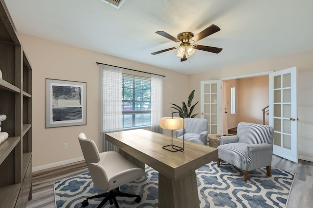 office space featuring french doors, ceiling fan, and wood-type flooring