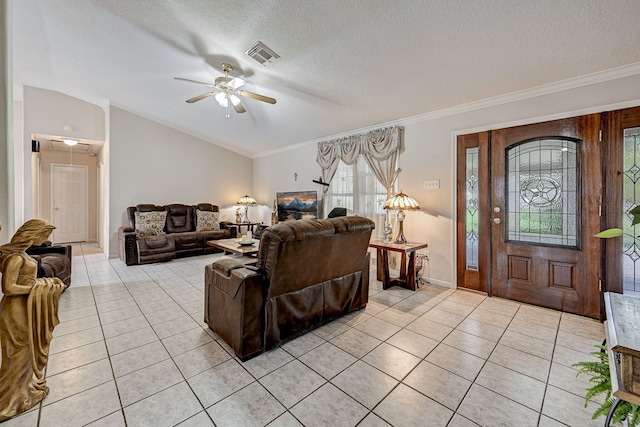 living room featuring ceiling fan, crown molding, light tile patterned floors, and a textured ceiling