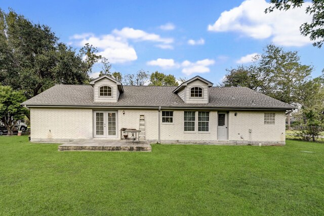 rear view of house featuring a yard and a patio