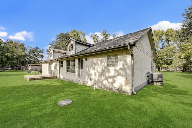 view of home's exterior featuring a yard, cooling unit, and a patio