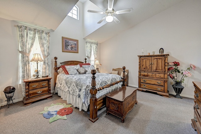 carpeted bedroom with ceiling fan, a textured ceiling, high vaulted ceiling, and multiple windows