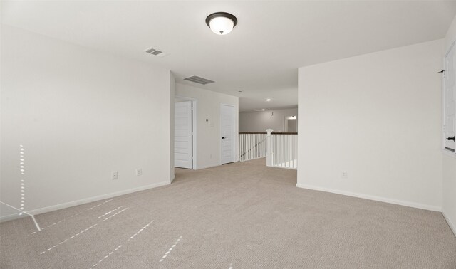 spare room featuring light colored carpet