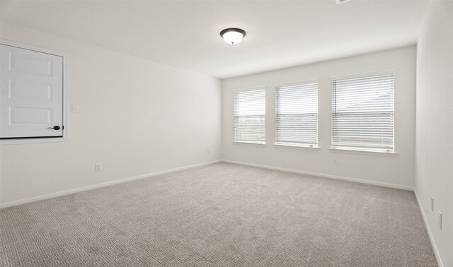 unfurnished room featuring light colored carpet