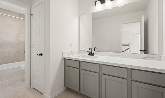 full bathroom with toilet, vanity, tiled shower / bath, and tile patterned floors