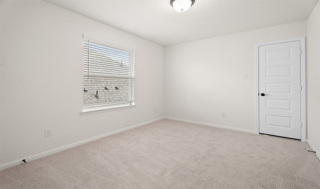 unfurnished room featuring light colored carpet