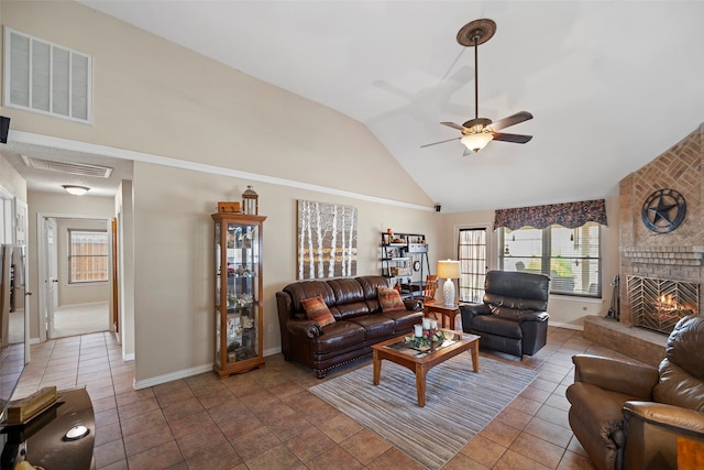 living room with a brick fireplace, high vaulted ceiling, ceiling fan, and tile patterned floors