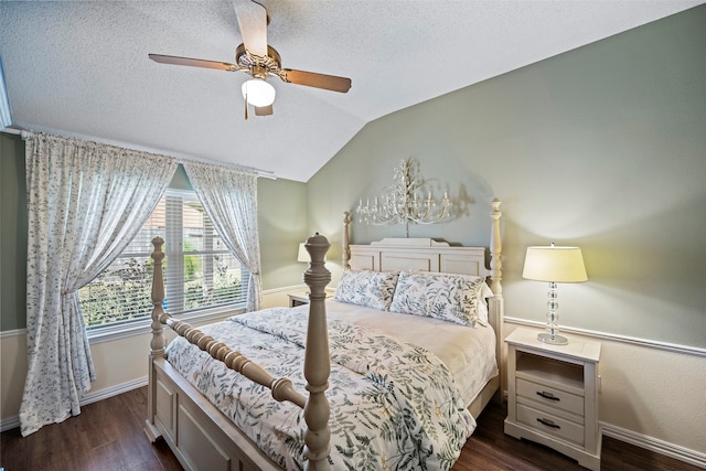 bedroom featuring ceiling fan, dark hardwood / wood-style floors, a textured ceiling, and lofted ceiling