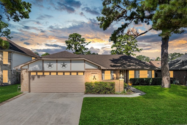 view of front of house with a garage and a yard