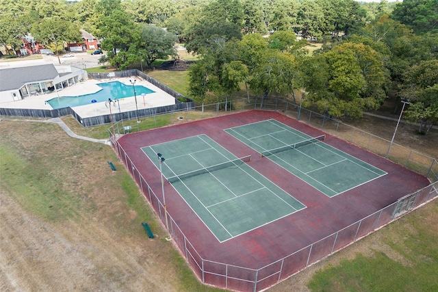 view of sport court featuring a fenced in pool