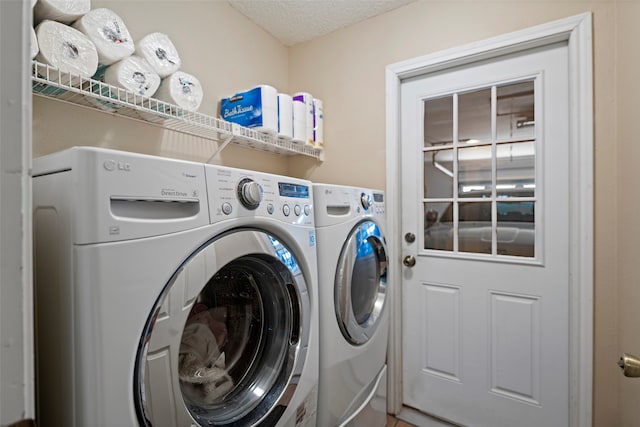 laundry area with a textured ceiling and independent washer and dryer