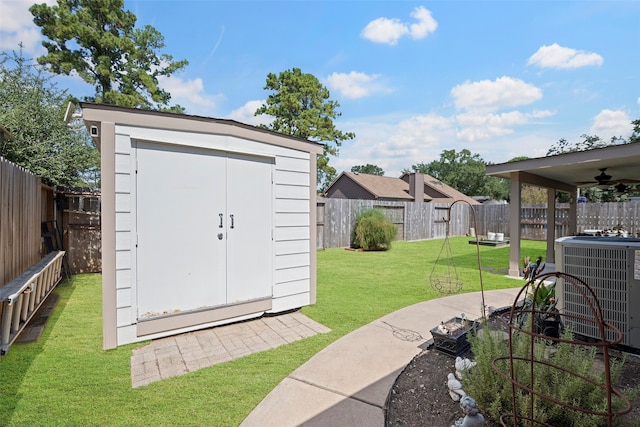 view of outdoor structure with central AC and a yard