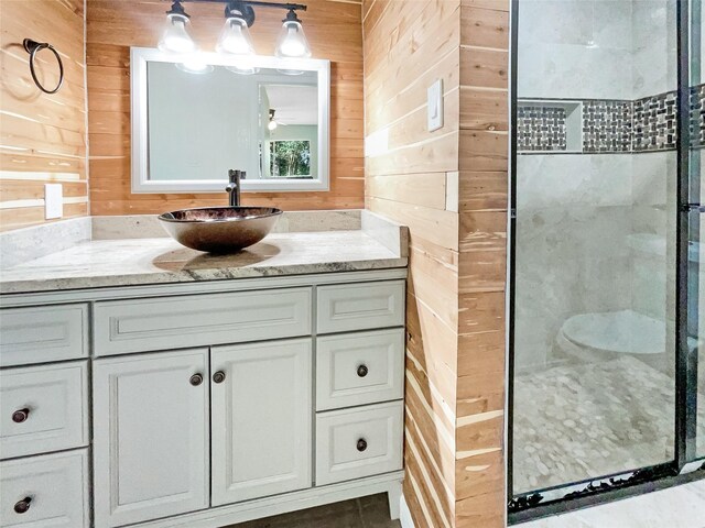 8719 Noble St, Needville, TX 77461 - bathroom featuring wooden walls, a shower stall, vanity, and a ceiling fan