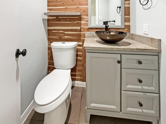 8719 Noble St, Needville, TX 77461 - bathroom with toilet, wood walls, vanity, and baseboards