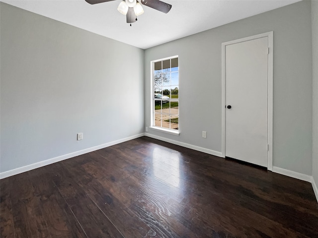 empty room featuring dark hardwood / wood-style flooring and ceiling fan