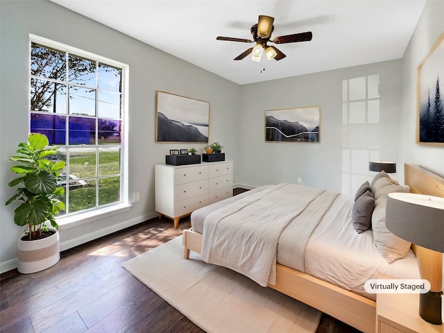 bedroom featuring dark wood-type flooring, multiple windows, and ceiling fan