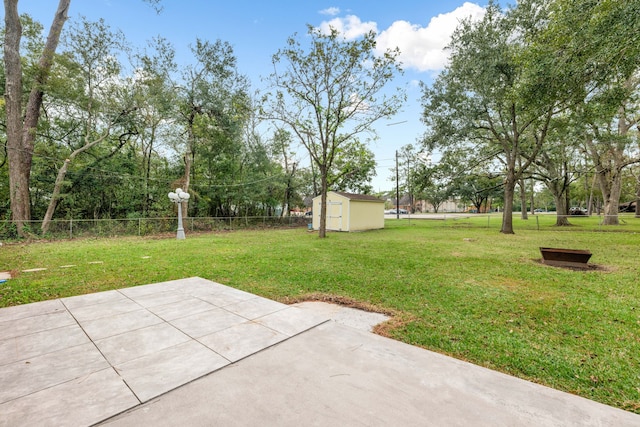 view of yard featuring a storage shed and a patio area