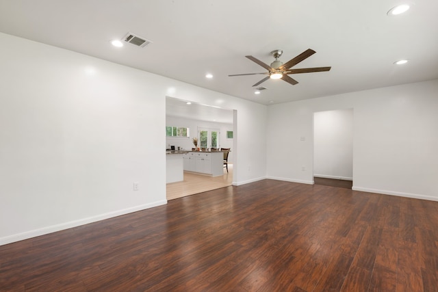 unfurnished room featuring ceiling fan and dark hardwood / wood-style floors