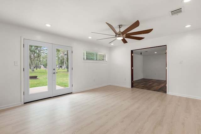 empty room featuring ceiling fan, light wood-type flooring, and french doors