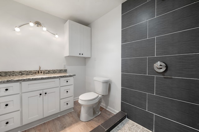 bathroom featuring hardwood / wood-style floors, vanity, and toilet