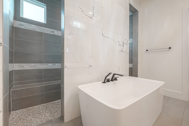 full bath with tile patterned flooring, a soaking tub, tile walls, and walk in shower