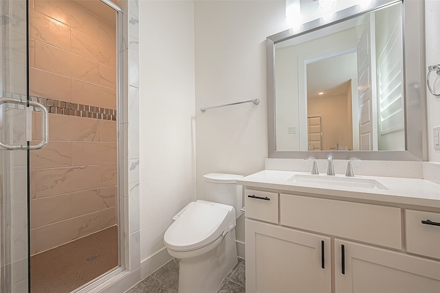 bathroom featuring toilet, a shower stall, and vanity