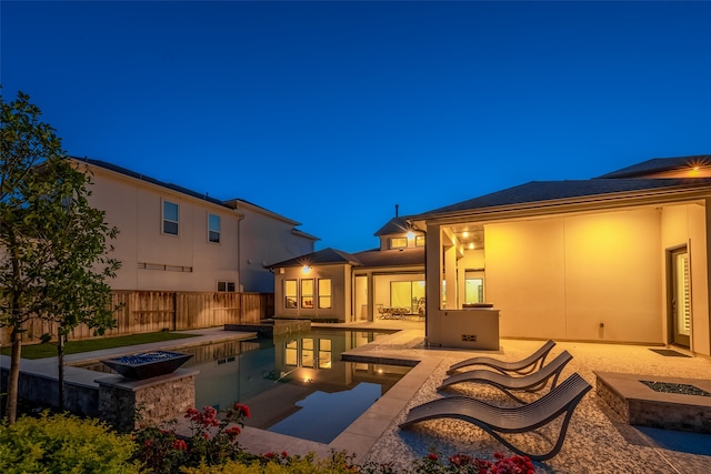 view of swimming pool featuring a fire pit, a patio, fence, and a fenced in pool