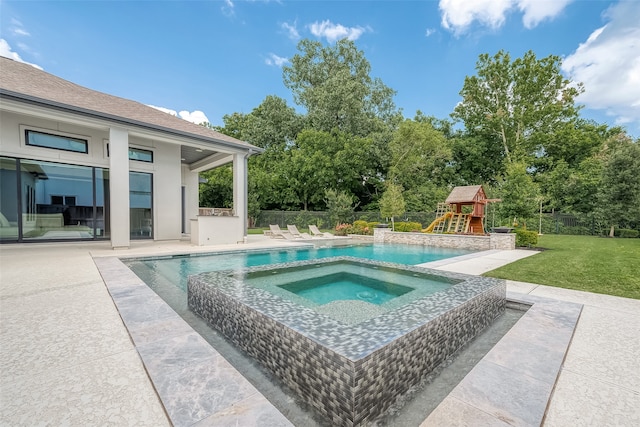 view of pool with a patio, an in ground hot tub, a playground, and a yard