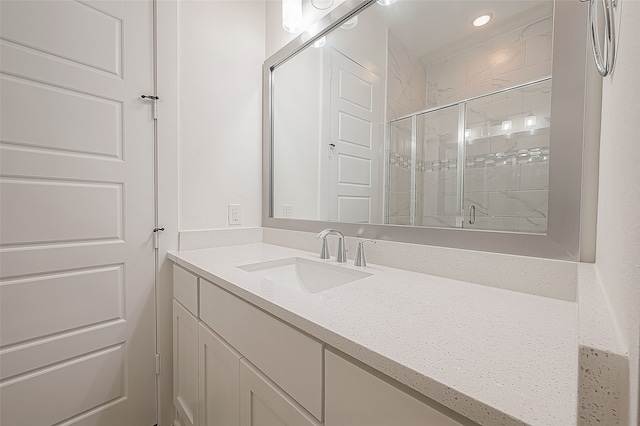 bathroom with vanity and a shower with shower door