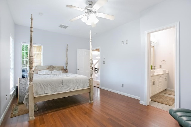 bedroom with ensuite bath, hardwood / wood-style flooring, and ceiling fan