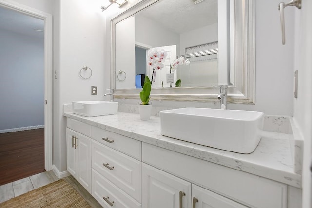 bathroom featuring hardwood / wood-style flooring and vanity