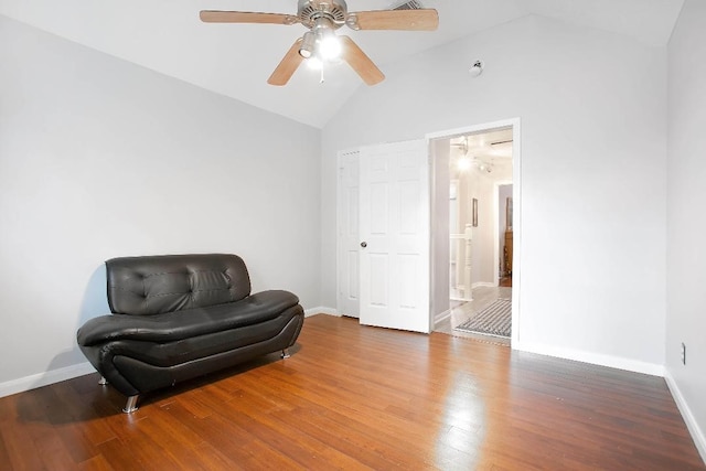 living area featuring hardwood / wood-style flooring, ceiling fan, and high vaulted ceiling