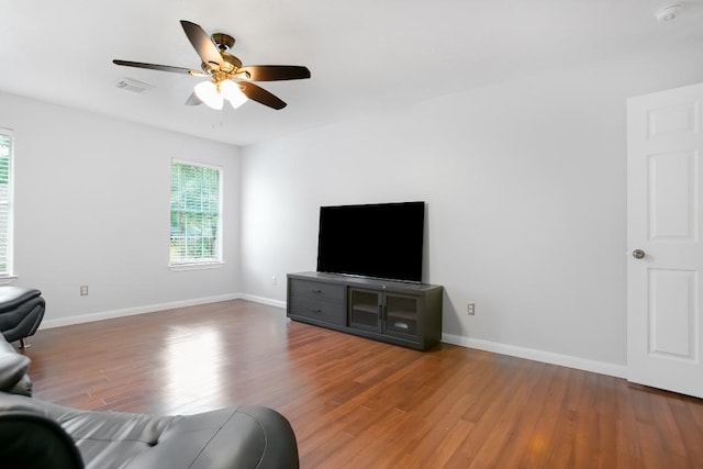 living room featuring ceiling fan and wood-type flooring