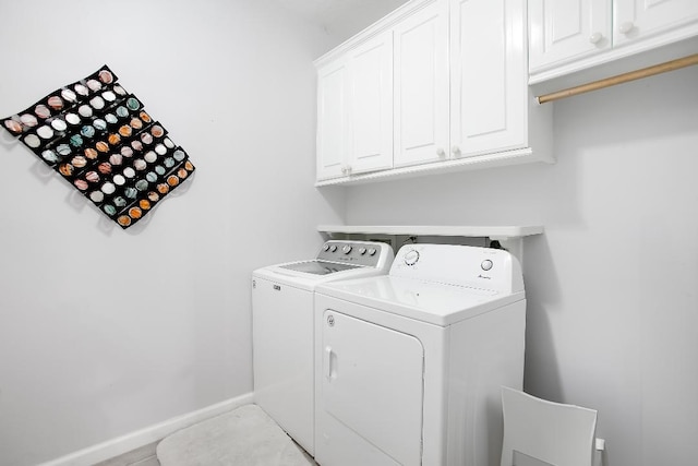 washroom with cabinets and washer and clothes dryer