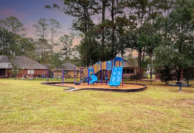 playground at dusk with a lawn