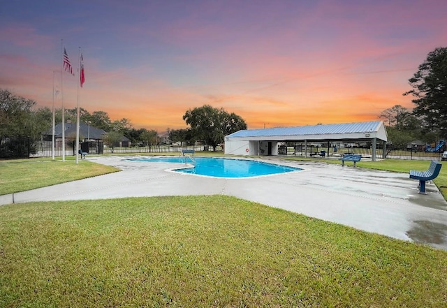 pool at dusk with a lawn