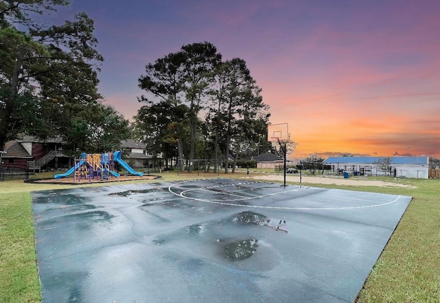 view of basketball court featuring a lawn and a playground