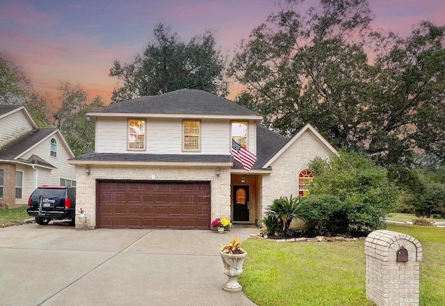 view of front facade with a garage and a lawn