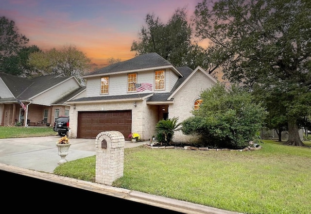 view of front of home with a garage and a lawn